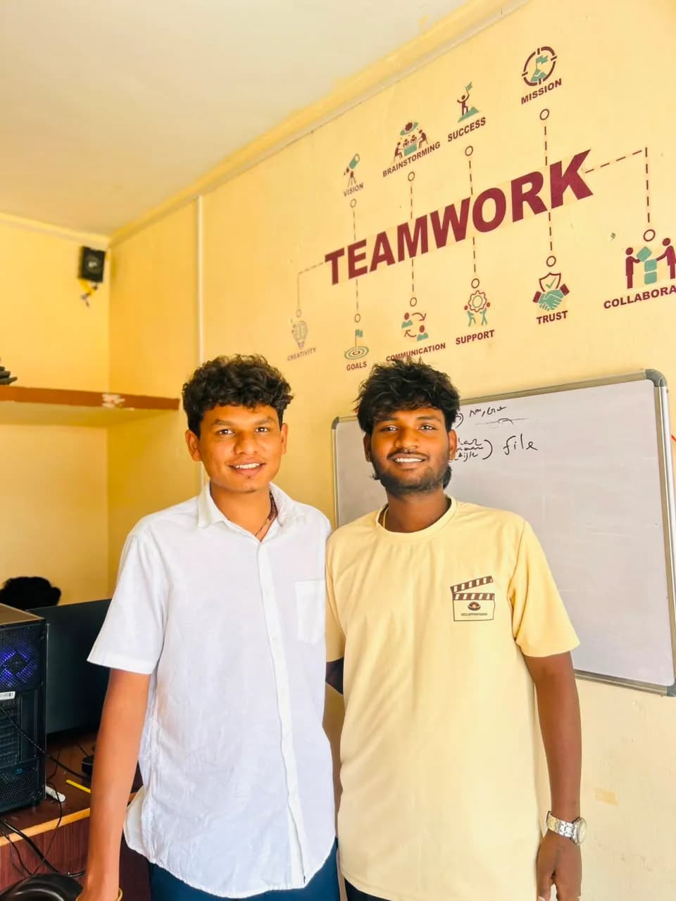 Team members in front of the office teamwork board